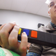 Using a brain implant, quadriplegic Ian Burkhart is now able to play Guitar Hero with his hands. (Image: Ohio State University/Batelle)